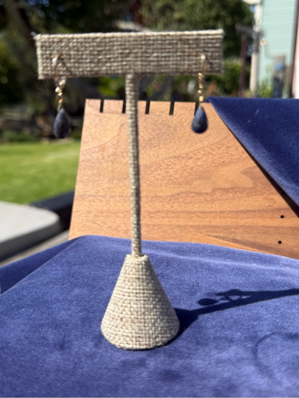 Blue Teardrop Dangle Earrings on Neutral Display Stand